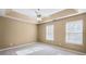 This bedroom features a tray ceiling with fan and two bright windows at 102 Timber Ridge Dr, Cartersville, GA 30121