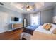 Serene main bedroom with tray ceiling, large windows, hardwood flooring, and view to walk-in closet at 1063 Emerson Avenue Se, Atlanta, GA 30316