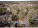 Aerial shot of a large wooded lot with mature trees and a home at the center at 566 Wagon Wheel Climb, Lawrenceville, GA 30044