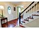 Foyer with hardwood floors, stained glass door and staircase showcasing the home's welcoming entrance at 566 Wagon Wheel Climb, Lawrenceville, GA 30044