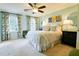 Serene bedroom with a king-size bed and plenty of natural light offering a calming personal space at 566 Wagon Wheel Climb, Lawrenceville, GA 30044