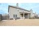 Back exterior view of the house with patio, backyard, and fenced perimeter at 58 Ashbury Cir, Dallas, GA 30157