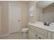 Bright bathroom with a single sink vanity, toilet and shower/tub combo with door to the left at 58 Ashbury Cir, Dallas, GA 30157