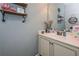 Charming half-bathroom with a white vanity, industrial shelves, and stylish decor for guests at 58 Ashbury Cir, Dallas, GA 30157