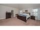 Spacious bedroom with a king bed, windows, and furniture at 58 Ashbury Cir, Dallas, GA 30157