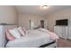Neutral bedroom features a comfy bed, white wood furniture, and a large TV for relaxing evenings at 58 Ashbury Cir, Dallas, GA 30157