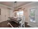 Cozy dining area offers a large table with bench seating, modern pendant lighting, and access to the backyard at 58 Ashbury Cir, Dallas, GA 30157