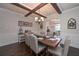Elegant dining room featuring a tray ceiling, wooden beams, classic chandelier, and seating for six at 58 Ashbury Cir, Dallas, GA 30157