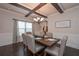 Comfortable dining room with a large window, traditional chandelier, seating for six, and access to kitchen at 58 Ashbury Cir, Dallas, GA 30157