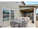 View of screened in porch and outdoor dining set on the back exterior of the home at 58 Ashbury Cir, Dallas, GA 30157