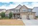 Charming two-story brick home featuring a two-car garage, well-manicured lawn, and a welcoming front porch at 58 Ashbury Cir, Dallas, GA 30157