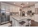 Bright kitchen boasts stainless steel appliances, granite countertops, kitchen island with seating and stylish pendant lighting at 58 Ashbury Cir, Dallas, GA 30157