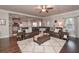 Spacious living room with stone archway, tile floors, ceiling fan, and an open layout to the kitchen at 58 Ashbury Cir, Dallas, GA 30157