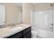 Bathroom featuring granite countertop, modern fixtures, a soaking tub and shower with white tile at 5995 Spring Way, Stonecrest, GA 30038