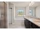 Bathroom with a double granite vanity, soaking tub under a window, and a separate walk-in shower at 5995 Spring Way, Stonecrest, GA 30038