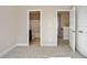 A carpeted bedroom with doors leading to a bathroom and hallway, offering a sense of privacy and access at 5995 Spring Way, Stonecrest, GA 30038