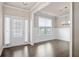 Bright dining room featuring large windows, hardwood floors, and stylish chandelier at 5995 Spring Way, Stonecrest, GA 30038