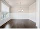 Bright dining room features dark hardwood floors, wainscoting, and modern chandelier at 5995 Spring Way, Stonecrest, GA 30038