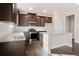 Modern kitchen featuring dark cabinets, stainless appliances, granite countertops, and island at 5995 Spring Way, Stonecrest, GA 30038