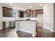 Modern kitchen with dark wood cabinets, stainless steel appliances, and granite countertops at 5995 Spring Way, Stonecrest, GA 30038