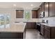 Well-lit kitchen featuring stainless steel appliances, granite counters, subway tile backsplash, and dark wood cabinetry at 5995 Spring Way, Stonecrest, GA 30038