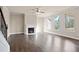 Spacious living room featuring hardwood floors, a fireplace, and large bright windows at 5995 Spring Way, Stonecrest, GA 30038