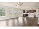 Open-concept living room with abundant natural light, dark hardwood floors, and modern ceiling fan at 5995 Spring Way, Stonecrest, GA 30038