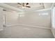 Spacious primary bedroom with a ceiling fan, and tray ceiling, providing a comfortable and stylish retreat at 5995 Spring Way, Stonecrest, GA 30038