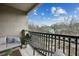 Relaxing balcony with seating, a small plant, and a view of the surrounding neighborhood and mature trees at 840 United Se Ave # 411, Atlanta, GA 30312