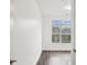 Bedroom with neutral walls, wood floors, bright lighting, and a large window showing a view of trees at 840 United Se Ave # 411, Atlanta, GA 30312