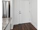 Clean entryway with a white door, stainless steel refrigerator, granite countertop, and vinyl floors at 840 United Se Ave # 411, Atlanta, GA 30312