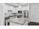 Modern kitchen featuring white cabinets, stainless steel appliances, granite countertops and kitchen island with pendant lights at 840 United Se Ave # 411, Atlanta, GA 30312