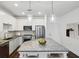 Stylish kitchen featuring stainless steel appliances, granite countertops, white cabinetry, and a center island at 840 United Se Ave # 411, Atlanta, GA 30312