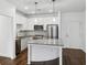 Modern kitchen featuring white cabinets, stainless steel appliances, a granite island, and stylish pendant lighting at 840 United Se Ave # 411, Atlanta, GA 30312