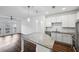 Open-concept kitchen with granite countertops, stainless steel appliances, open to a living room with natural light at 840 United Se Ave # 411, Atlanta, GA 30312