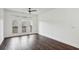 Bright living room with dark wood flooring, ceiling fan, and balcony access with natural light at 840 United Se Ave # 411, Atlanta, GA 30312