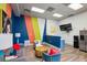Modern lounge with colorful accents, a large TV, and a kitchenette with stainless steel refrigerator at 840 United Se Ave # 411, Atlanta, GA 30312