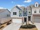 Attractive townhome with a brick-accented facade, a two-car garage, and a landscaped front yard at 126 Maple Creek Way, Woodstock, GA 30188