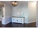 Well-appointed dining room featuring dark hardwood floors, stylish light fixture, and built-in cabinet at 172 Cherokee Reserve Cir, Canton, GA 30115