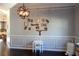 Elegant dining room with modern lighting, hardwood floors, and decorative wall art at 172 Cherokee Reserve Cir, Canton, GA 30115