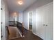 Upstairs hallway featuring hardwood floors, staircase, and access to bedrooms at 172 Cherokee Reserve Cir, Canton, GA 30115