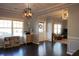 Bright living room with dark hardwood floors, stylish lighting, and neutral paint at 172 Cherokee Reserve Cir, Canton, GA 30115