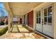 Cozy front porch with stone flooring, outdoor seating, and a view of the front yard at 260 Pinebrook Way, Roswell, GA 30076