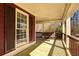 Covered porch includes wooden railings, tongue-and-groove ceiling, and a porch swing at 260 Pinebrook Way, Roswell, GA 30076