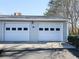 Attached garage with two white doors, each with window panels at 2931 Lavista Way, Decatur, GA 30033