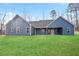 Spacious backyard featuring a covered patio and well-maintained lawn, perfect for outdoor activities at 602 Sandhill Hickory Level Rd, Carrollton, GA 30116