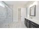 Bathroom showcasing a glass-enclosed shower, dark vanity, and tile floors at 602 Sandhill Hickory Level Rd, Carrollton, GA 30116