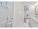 Bathroom with tile floors, tub with tile surround, and vanity with light countertops at 602 Sandhill Hickory Level Rd, Carrollton, GA 30116