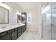 Bathroom featuring double sinks, dark cabinets, modern fixtures, and a glass-enclosed shower at 602 Sandhill Hickory Level Rd, Carrollton, GA 30116