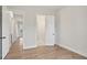 Spacious bedroom with hardwood floors, white trim and doors leading to other rooms at 602 Sandhill Hickory Level Rd, Carrollton, GA 30116
